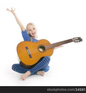young happy blond girl in blue with guitar against white background