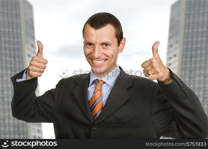 Young happy business man showing thumbs up