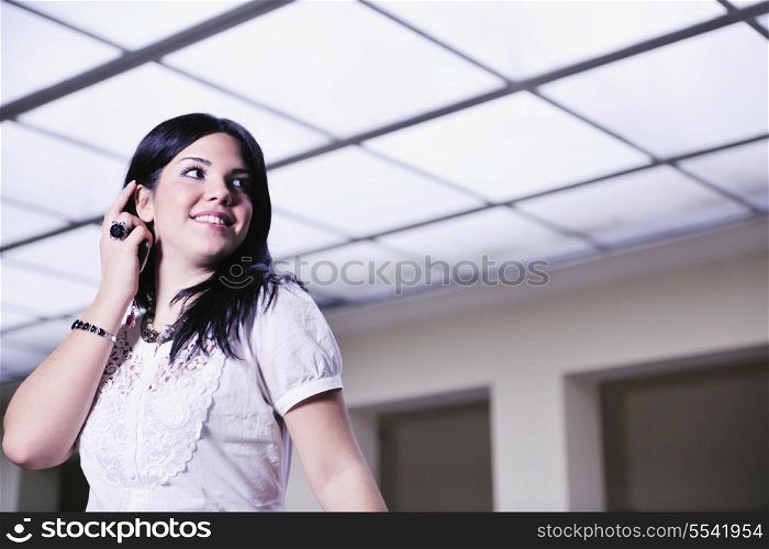 young happy business woman or student posing in fashionable clothes indoor in bright building