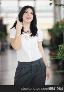 young happy business woman or student posing in fashionable clothes indoor in bright building