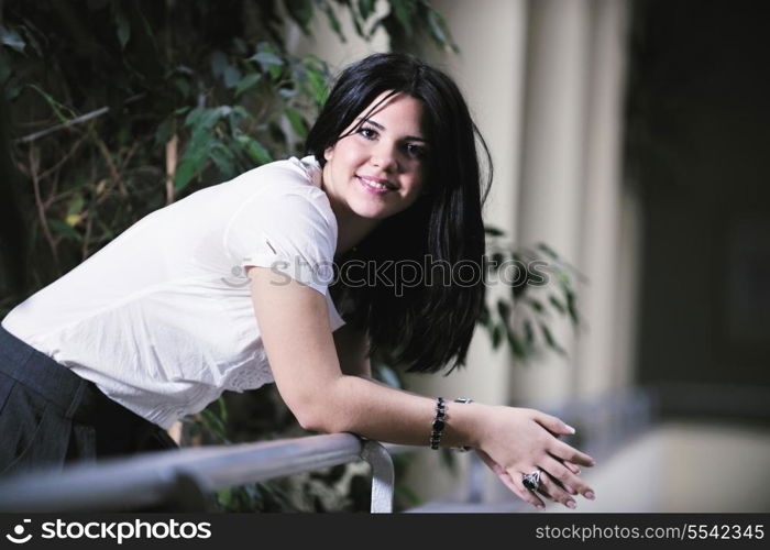 young happy business woman or student posing in fashionable clothes indoor in bright building