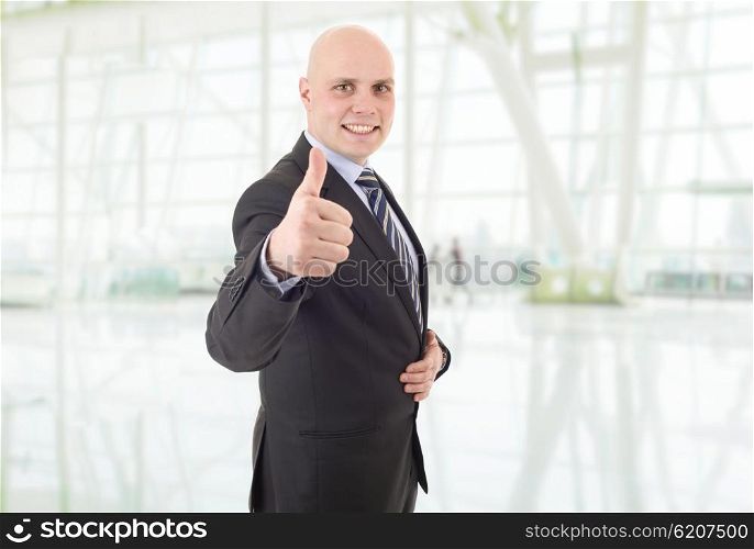 young happy businessman going thumb up, at the office