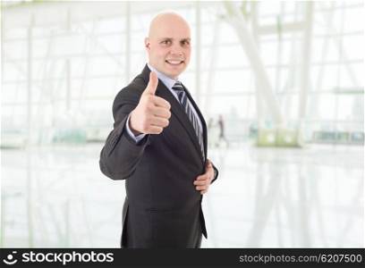 young happy businessman going thumb up, at the office