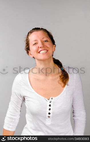 young happy caucasian woman on grey background