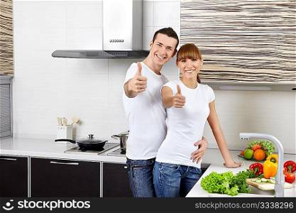 Young happy couple at kitchen