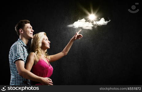 Young happy couple. Conceptual image of young couple hugging each other and dreaming