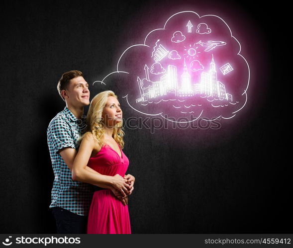 Young happy couple. Conceptual image of young couple hugging each other and dreaming