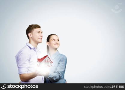 Young happy couple. Conceptual image of young couple hugging each other and dreaming