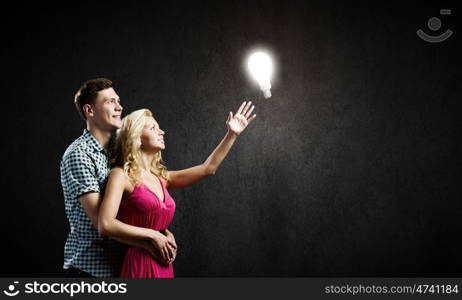 Young happy couple. Conceptual image of young couple hugging each other and dreaming