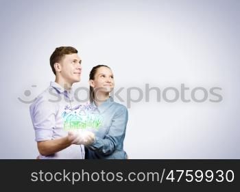 Young happy couple. Conceptual image of young couple hugging each other and dreaming