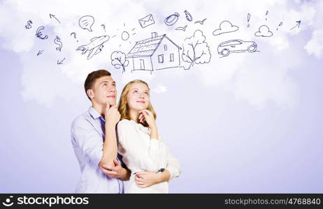 Young happy couple. Conceptual image of young couple hugging each other and dreaming