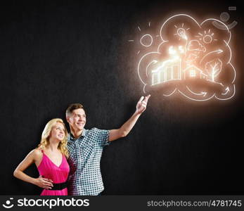 Young happy couple. Conceptual image of young couple hugging each other and dreaming