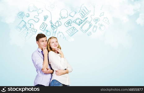 Young happy couple. Conceptual image of young couple hugging each other and dreaming