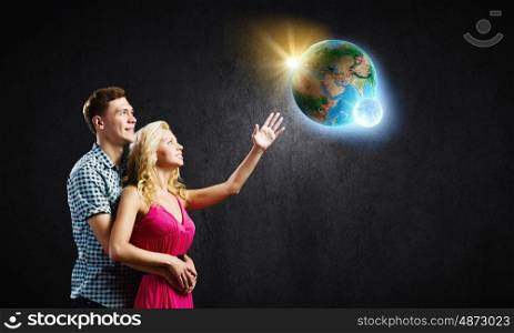 Young happy couple. Conceptual image of young couple hugging each other and dreaming. elements of this image are furnished by NASA