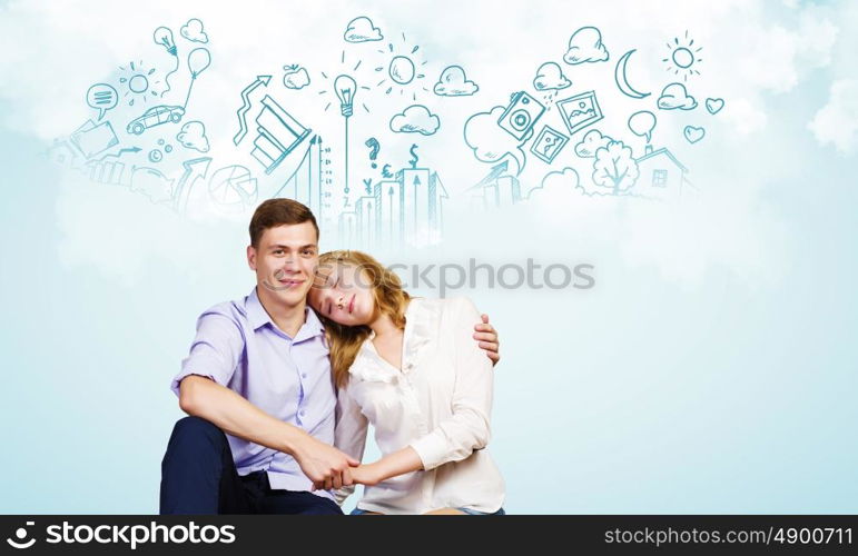 Young happy couple. Conceptual image of young couple hugging each other and dreaming