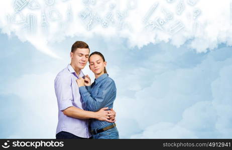 Young happy couple. Conceptual image of young couple hugging each other and dreaming