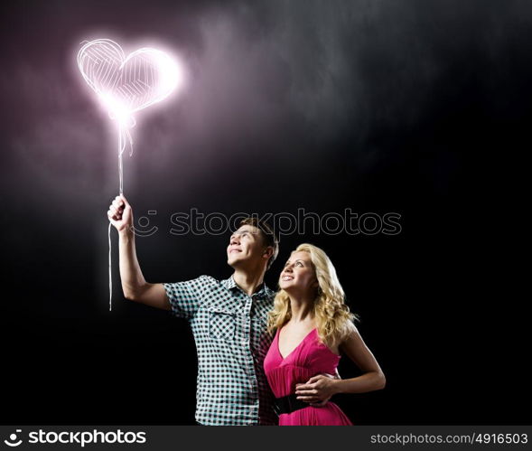 Young happy couple. Conceptual image of young couple hugging each other and dreaming