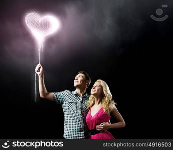 Young happy couple. Conceptual image of young couple hugging each other and dreaming