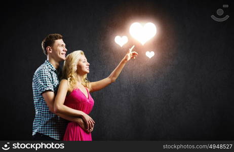 Young happy couple. Conceptual image of young couple hugging each other and dreaming