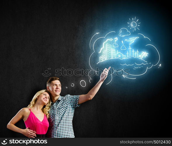 Young happy couple. Conceptual image of young couple hugging each other and dreaming