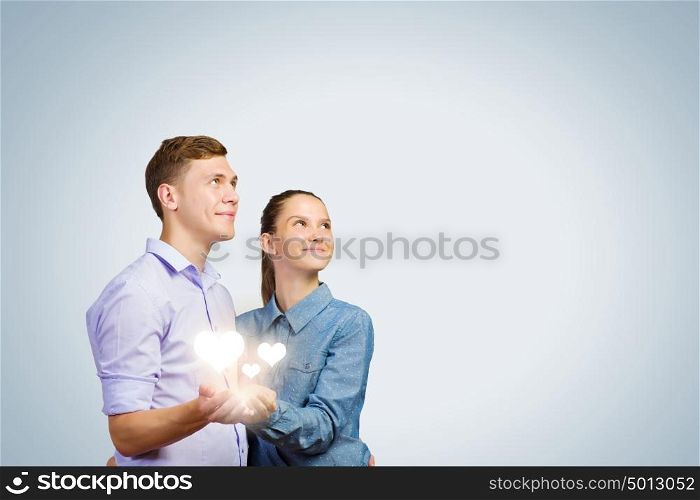 Young happy couple. Conceptual image of young couple hugging each other and dreaming