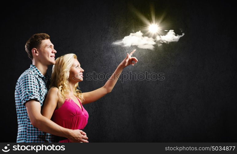 Young happy couple. Conceptual image of young couple hugging each other and dreaming