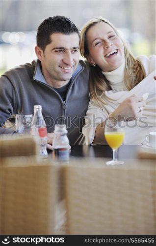 young happy couple have fun on coffee break at bright morning