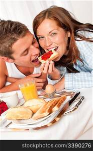 Young happy couple having luxury hotel breakfast