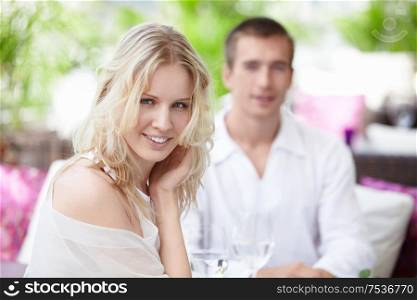 Young happy couple in a white restaurant