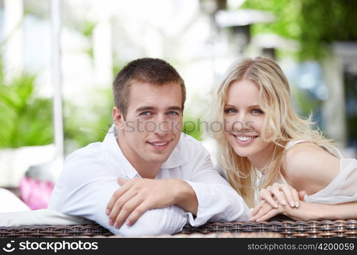 Young happy couple in love at a restaurant