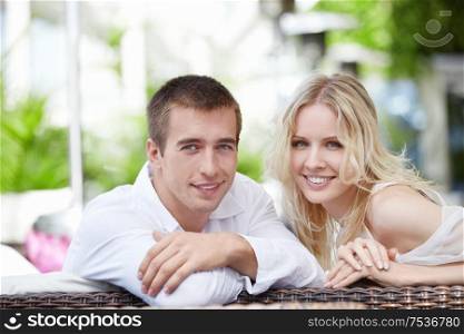 Young happy couple in love at a restaurant