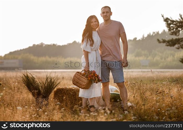 young happy couple in love hugging on nature. Man and woman hugging, sunlight in summer meadow. Happy family in the evening sun light. The concept holiday. valentine&rsquo;s day.. young happy couple in love hugging on nature. Man and woman hugging, sunlight in summer meadow. Happy family in the evening sun light. The concept holiday. valentine&rsquo;s day