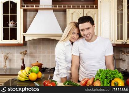 Young happy couple in white on kitchen