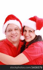Young happy couple near with Santa hats. Isolated over white background