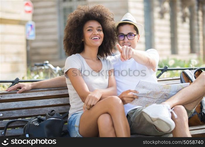 young happy couple on a bench at the park