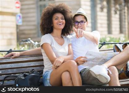 young happy couple on a bench at the park