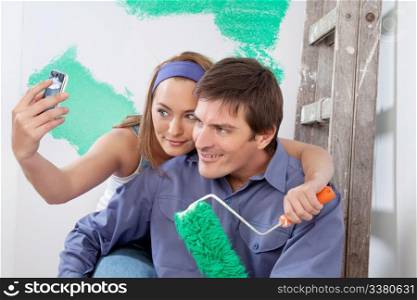 Young happy couple taking a snapshot of themselves with cellphone