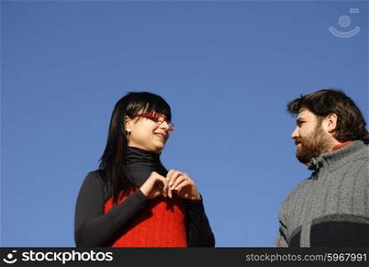 young happy couple with the sky as background