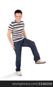 Young happy easygoing casual man standing on one leg isolated on white background