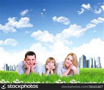 Young happy family outdoor on the ground