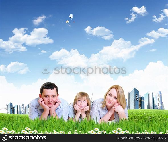Young happy family outdoor. Young happy family outdoor on the ground