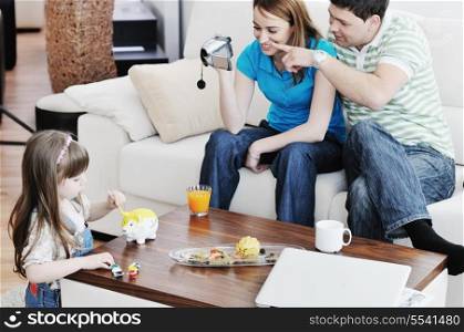 young happy family recording by video camera their child at home