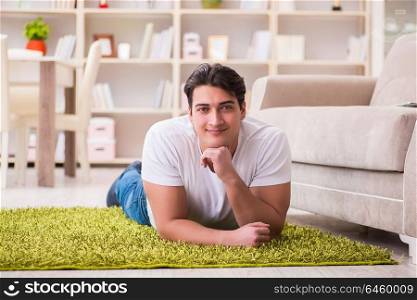 Young happy handsome man on carpet floor