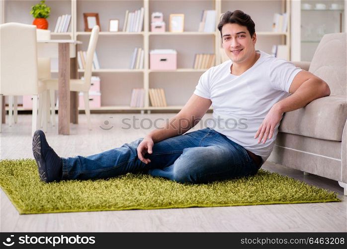 Young happy handsome man on carpet floor