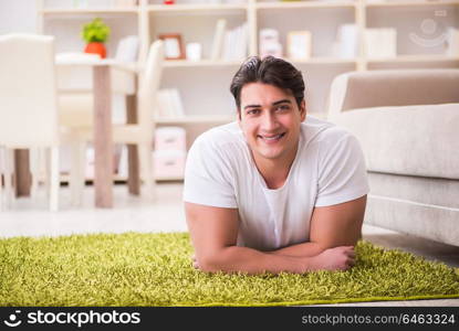 Young happy handsome man on carpet floor