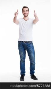 Young happy handsome man with thumbs up sign in casuals in full growth - isolated on white.