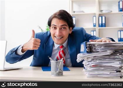 Young happy male employee in the office 