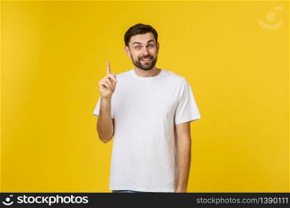 Young happy man gets good idea, raises fore finger as going to voice it, being glad have genius thoughts in mind, isolated over white background. Young happy man gets good idea, raises fore finger as going to voice it, being glad have genius thoughts in mind, isolated over white background.