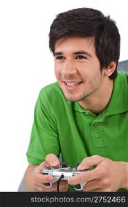 Young happy man playing video game with control pad on white background