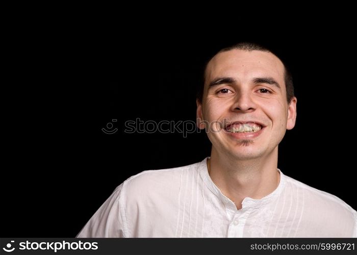 young happy man portrait, on a black background